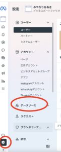 Vertical left navigation showing a highlighted 'データソース' (Data Sources) menu item; a round orange circle highlights a gear/settings button at the bottom-left.